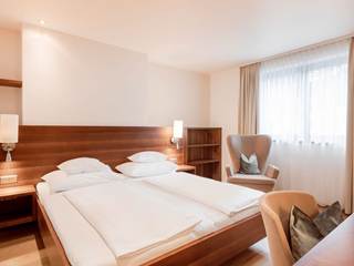Hotelzimmer mit Bett und Schreibtisch